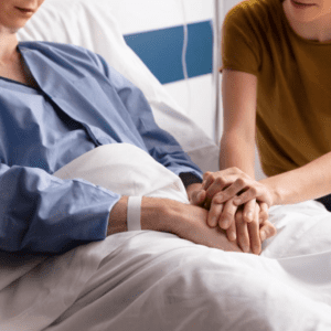 A lady comforting a patient in hospice care